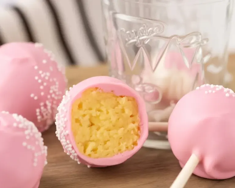 A delicious homemade Starbucks Cake Pop decorated with pink candy melts and sprinkles.