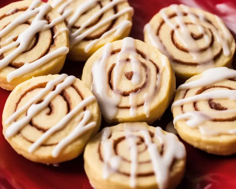 Delicious Cinnamon Roll Cookies with icing, featuring cinnamon and sugar swirls.