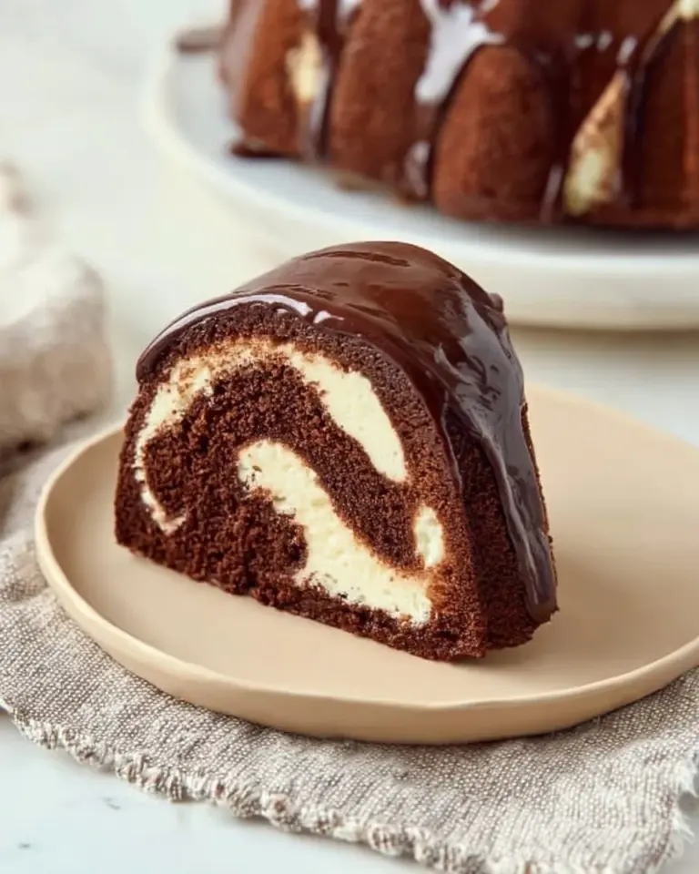 Chocolate Cream Cheese Swirl Bundt Cake topped with chocolate drizzle