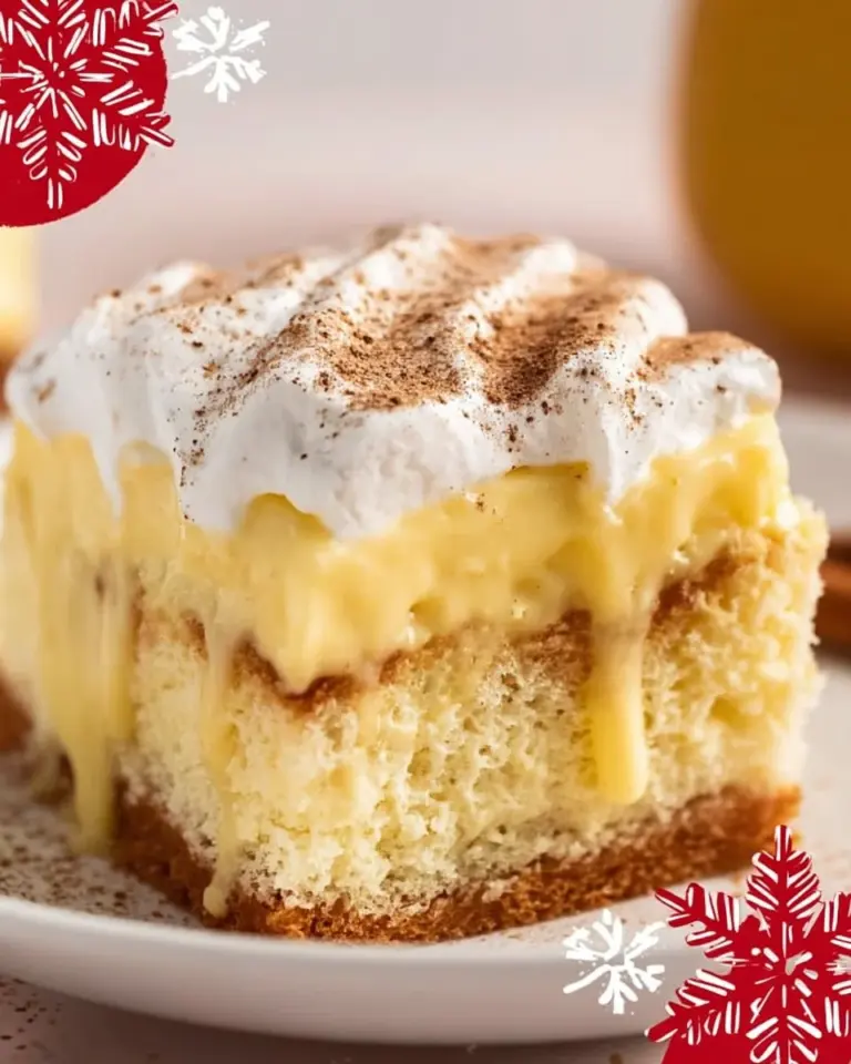 Festive Eggnog Poke Cake topped with whipped cream and nutmeg garnish