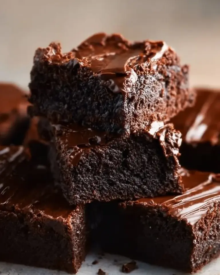 Fudgy chocolate ganache brownies on a decorative plate