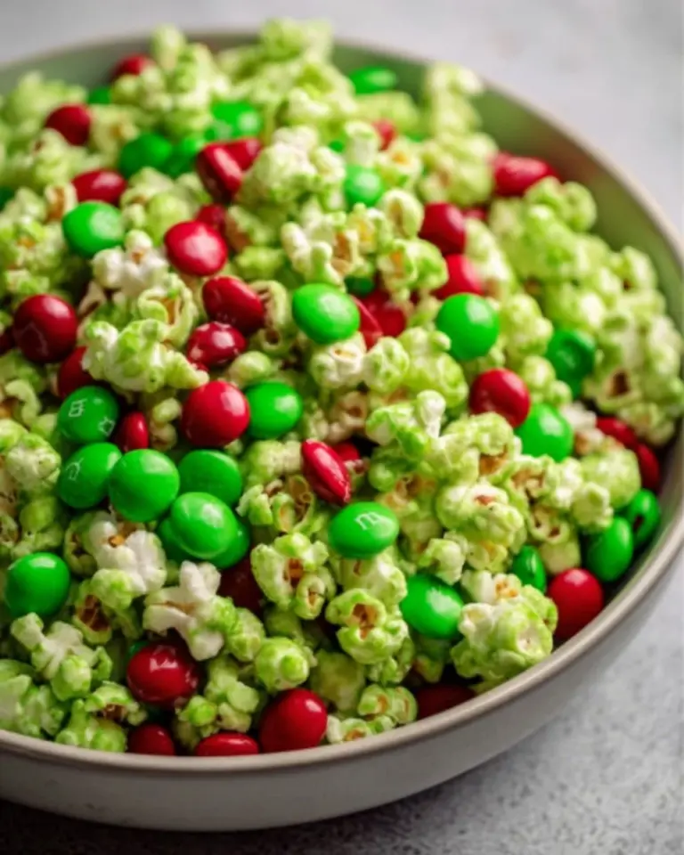 Colorful Grinch popcorn mix in a festive bowl for holiday celebrations