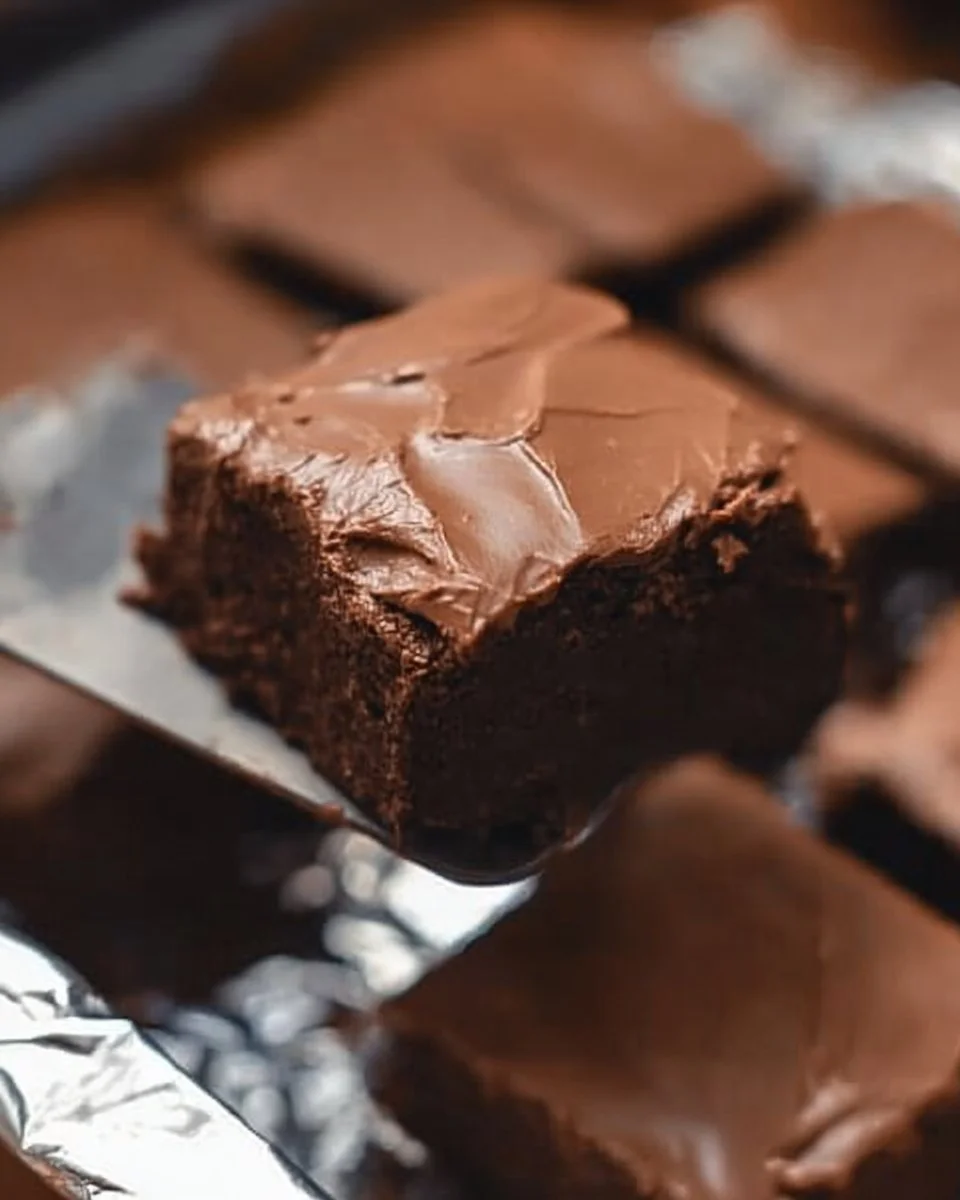 Decadent Lunch Lady Brownies with chocolate frosting on a plate