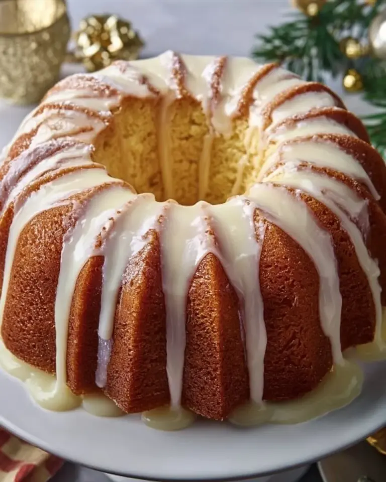 Rich Christmas Eggnog Bundt Cake topped with creamy frosting and festive decorations.