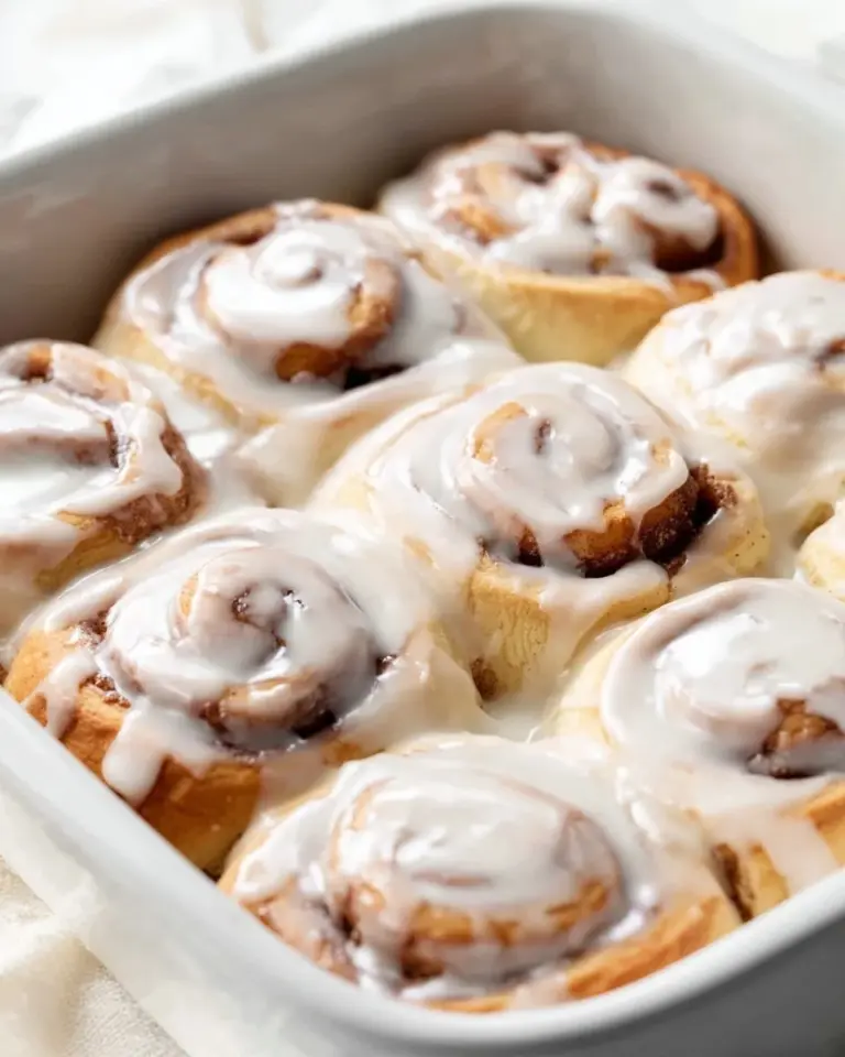 Freshly baked ultimate homemade cinnamon rolls on a cooling rack