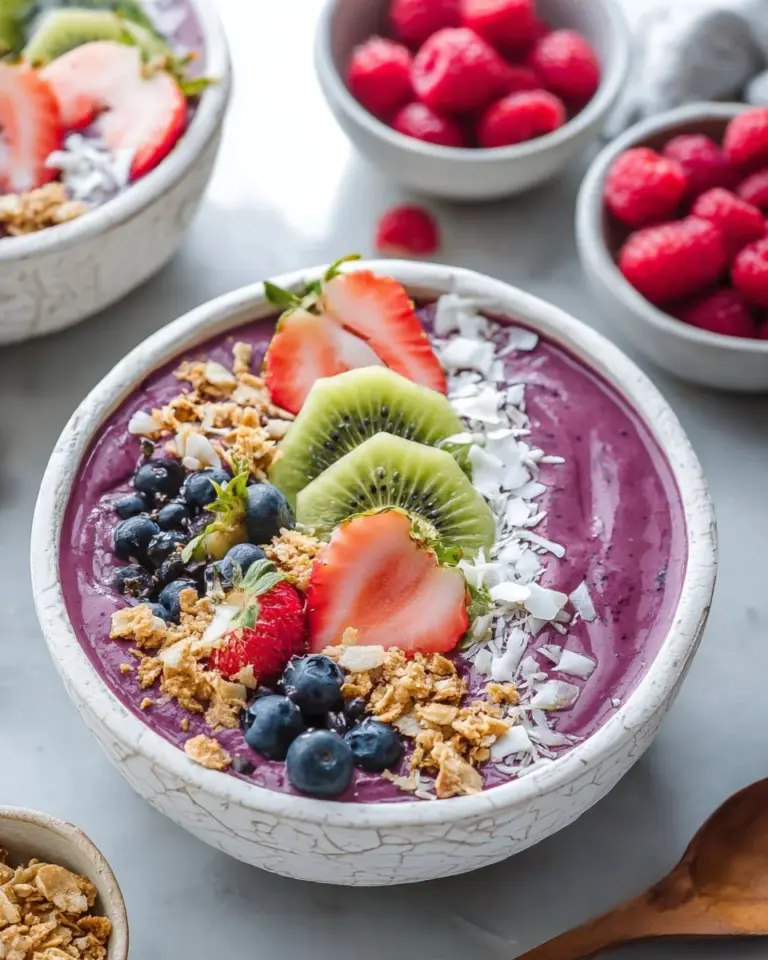 Berry acai smoothie bowl topped with fresh fruits and nuts