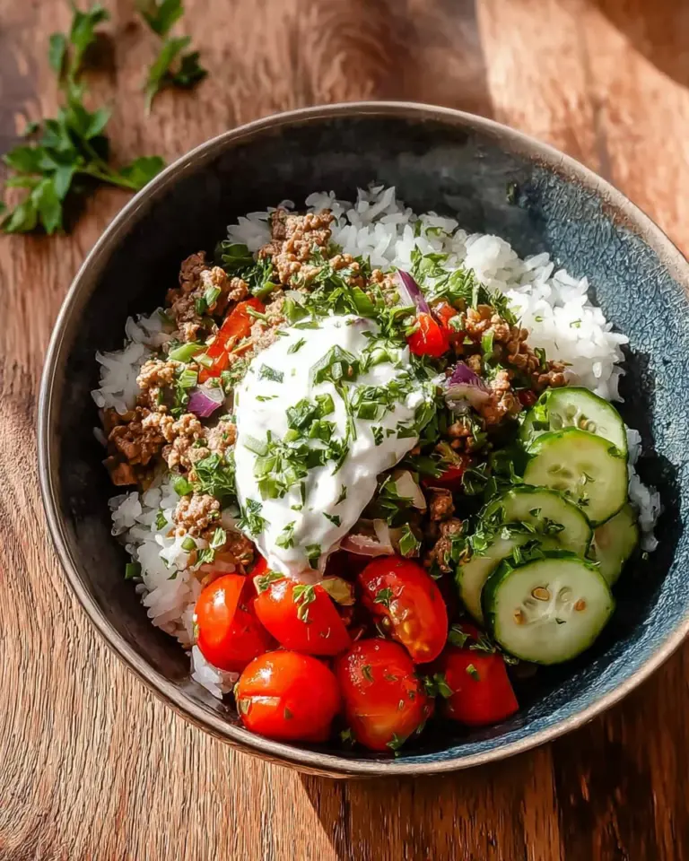 Delicious Greek ground turkey rice bowls served in a bowl with fresh vegetables