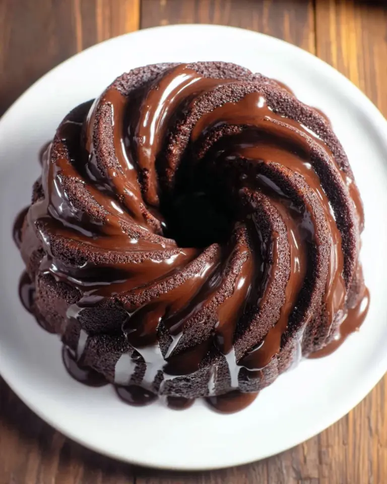 Delicious homemade air fryer cake with frosting and berries on top.