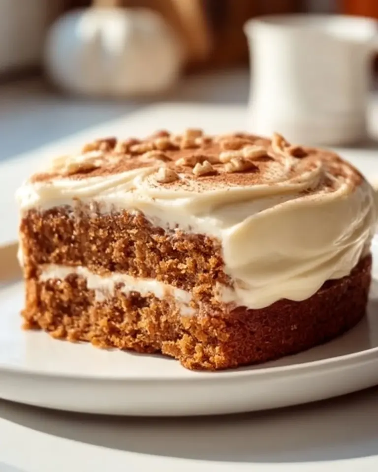 Delicious spiced carrot cake topped with cream cheese frosting and decorated with walnuts.