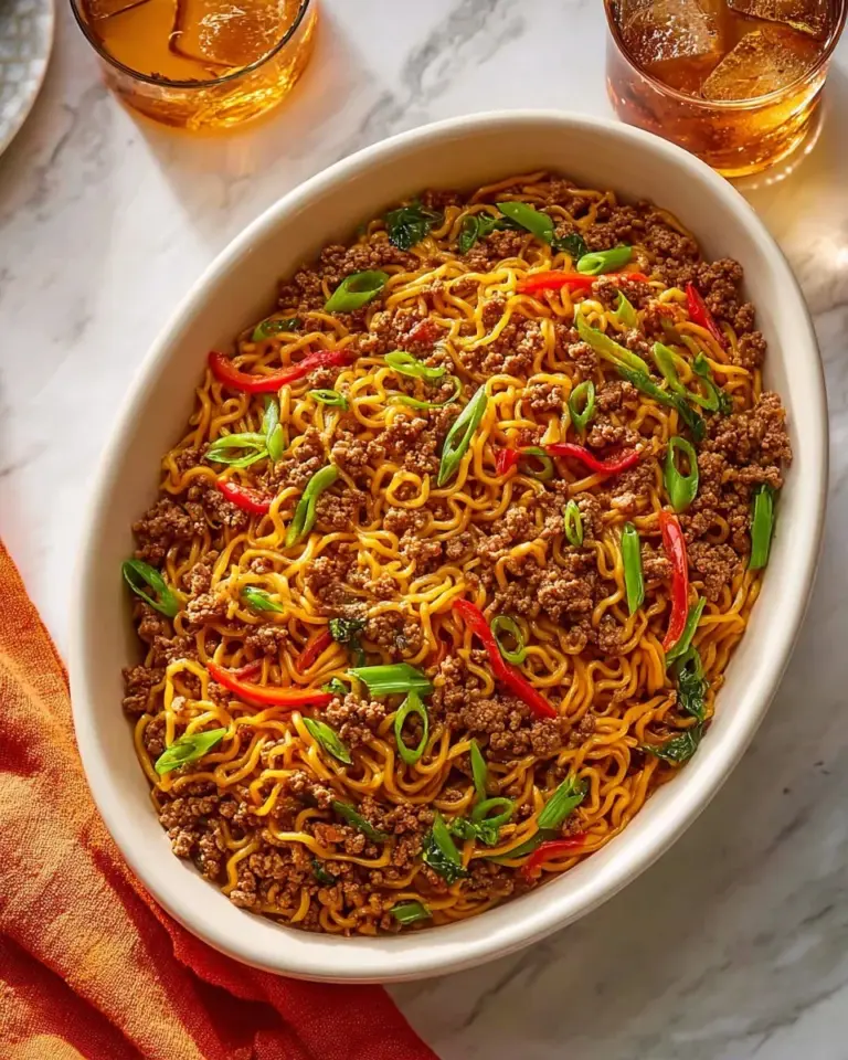 A bowl of homemade Crock Pot Ramen noodles topped with fresh vegetables.