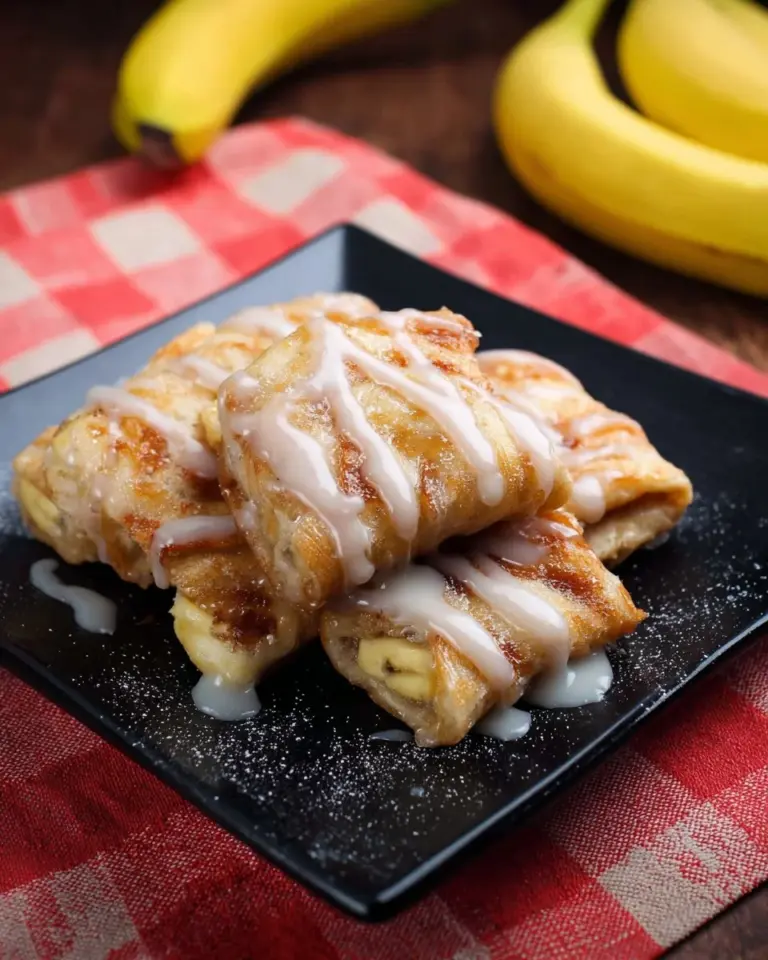 Delicious Thai Banana Roti served with drizzled chocolate and sprinkled sugar.